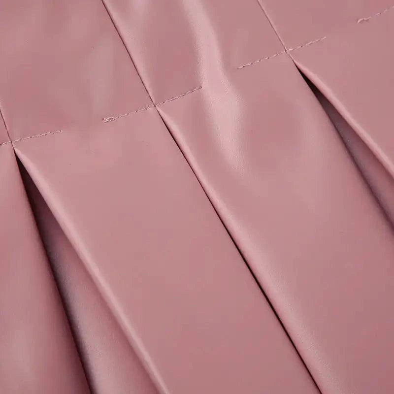 Mandotos Spice Faux Leather Pleated Mini skirt showcasing its textured pleats and rich faux leather material.
