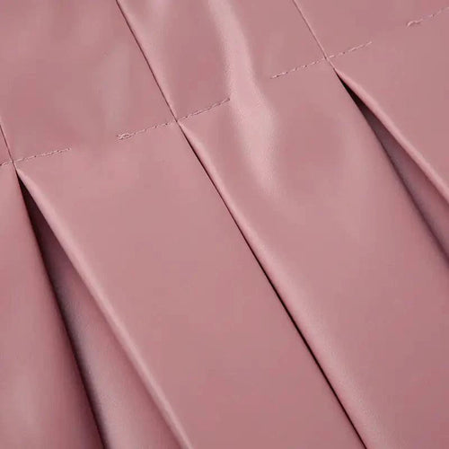 Mandotos Spice Faux Leather Pleated Mini skirt showcasing its textured pleats and rich faux leather material.