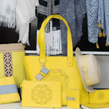 Mandotos Sprout Leather Tote bag in bright lemon yellow with sturdy handles and spacious interior.