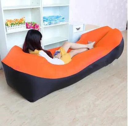 Mandotos SunScape Inflatable Lounger in vibrant orange with built-in pillow, designed for outdoor relaxation and effortless comfort.