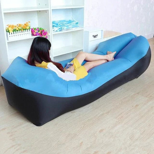 Mandotos SunScape inflatable lounger filled with air, showcasing a portable outdoor relaxation chair on a grassy area.