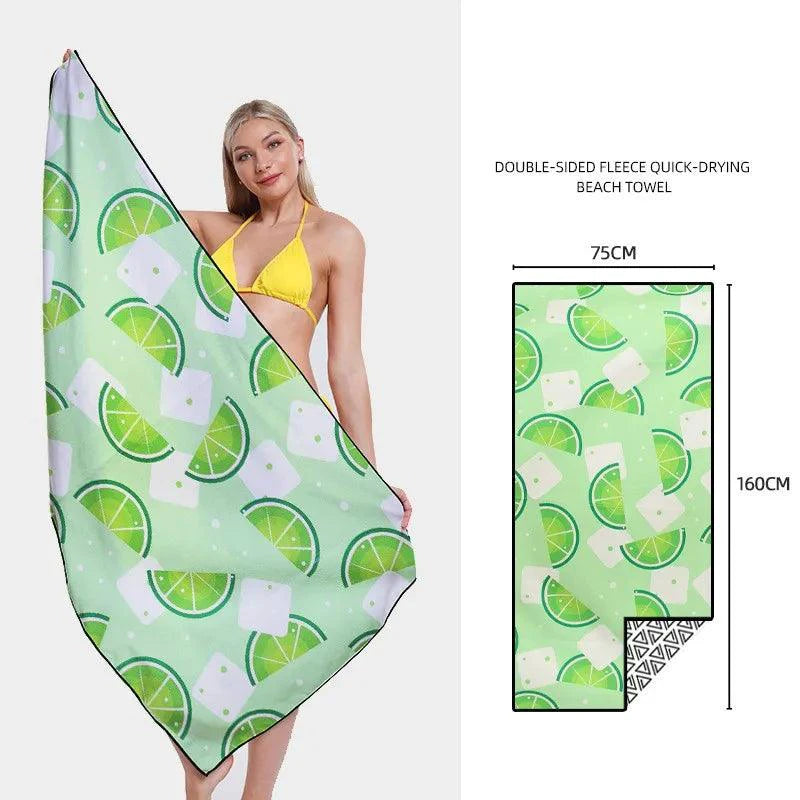 Mandotos SwiftDry patterned beach towel with colorful geometric design laid flat on sand.