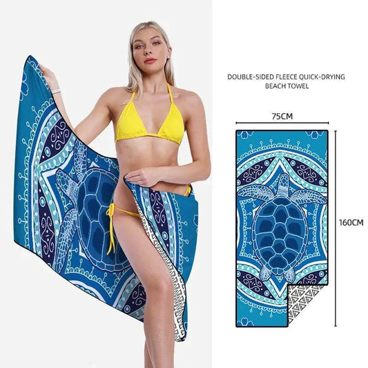 Mandotos SwiftDry patterned beach towel featuring colorful geometric designs laid out on the sand.