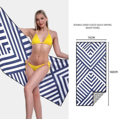 Mandotos SwiftDry patterned beach towel with colorful geometric design laid out on sandy beach