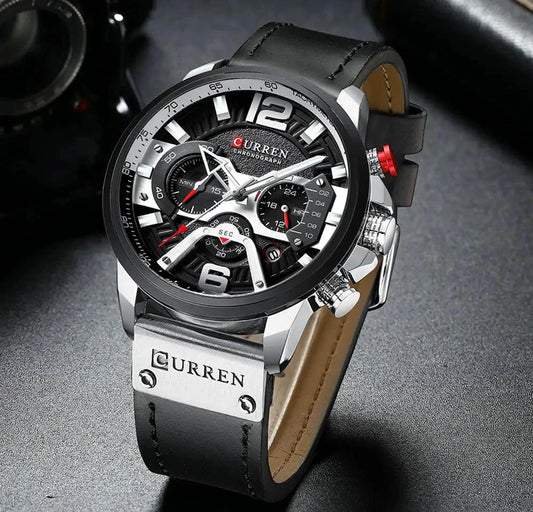 Mandotos Tactical Elegance leather watch with black dial, stainless steel case, and brown leather strap on a minimalist background.