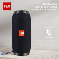 Mandotos TG117 Bluetooth portable waterproof TWS outdoor speaker placed on a surface with a nature background.