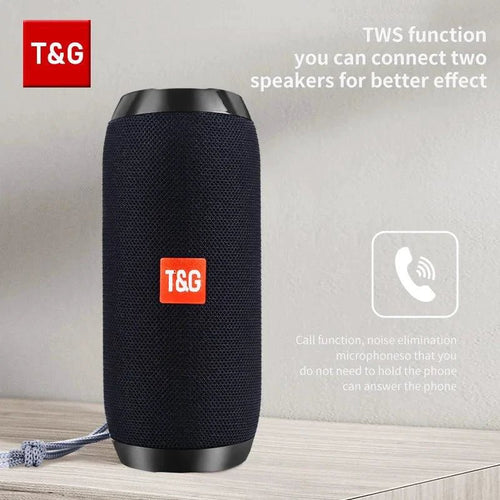 Mandotos TG117 Bluetooth portable waterproof TWS outdoor speaker placed on a surface with a nature background.