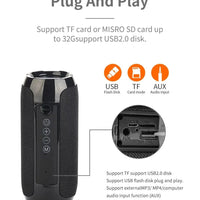 Mandotos TG117 Bluetooth portable waterproof TWS outdoor speaker on a table showing its compact design and rugged exterior.