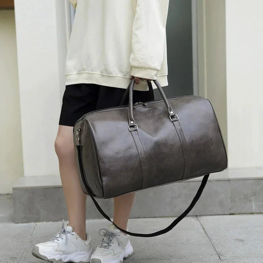 Mandotos men's travel bag in PU leather with large capacity, shoulder strap, and stylish tote design for men and women.