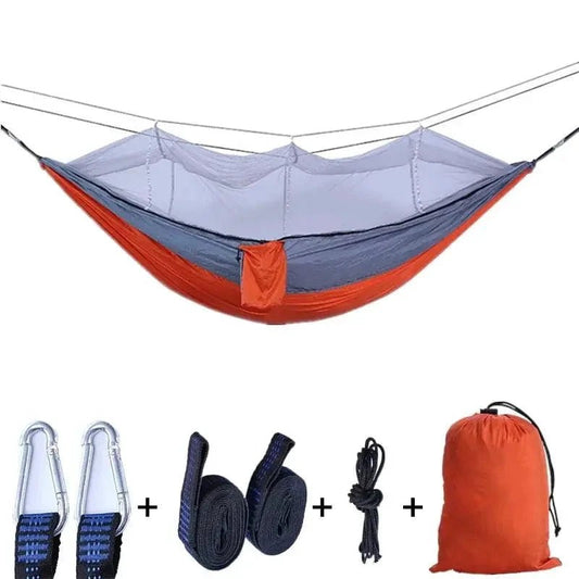 Mandotos Traveler's Mosquito-Free Hammock set up outdoors with mesh sides and comfortable fabric for outdoor relaxation.