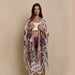 Mandotos Urban Blossom Kimono displayed on a hanger, featuring floral patterns and lightweight fabric for versatile styling.
