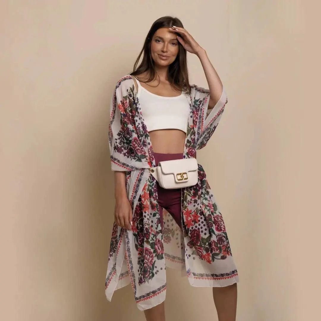 Mandotos Urban Blossom Kimono with floral pattern, lightweight fabric, and wide sleeves, displayed hanging on a wooden hanger.