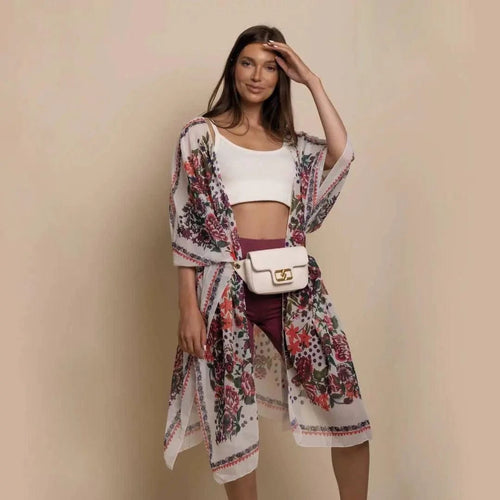 Mandotos Urban Blossom Kimono with floral pattern, lightweight fabric, and wide sleeves, displayed hanging on a wooden hanger.