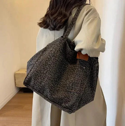 Urban Leopard Canvas Tote bag by MANDOTOS featuring leopard print fabric with sturdy handles and spacious interior.