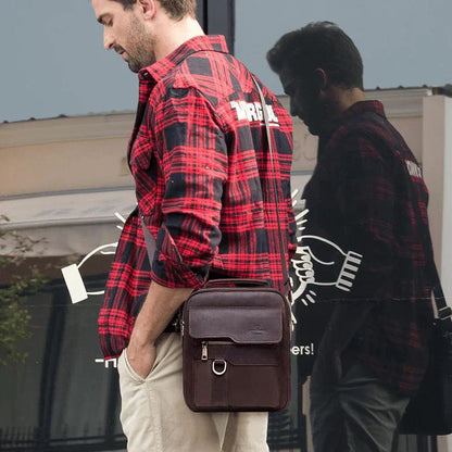Vintage leather messenger bag by MANDOTOS, showing the classic brown leather design with adjustable shoulder strap and front flap.