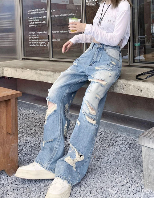 Plus size American Hole high waist straight-leg denim pants for women by MANDOTOS, showing front view with distressed details.