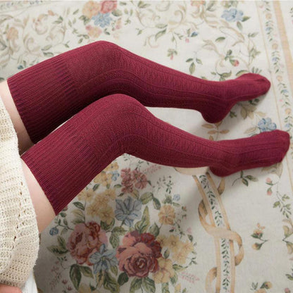 Mandotos women's solid color warm knee-high socks, soft and cozy for stylish winter wear.