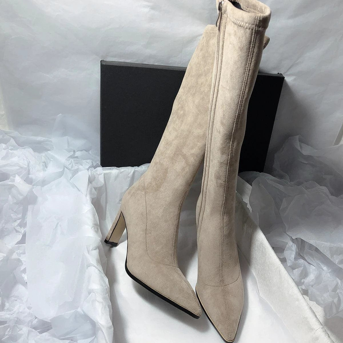 Mandotos women's high heel stretch below-the-knee boots showing sleek design and pointed toe on a neutral background.