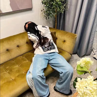 Mandotos Y2K baggy denim jeans with embroidered stripes, wide-leg fit, streetwear style for men and women, casual hip-hop look.