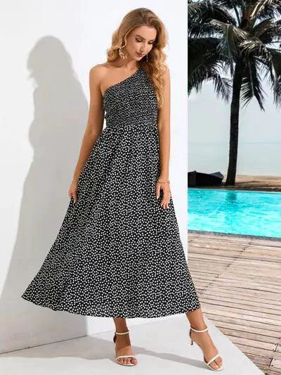 Mandotos Zoe asymmetrical midi dress featuring a flowy silhouette and stylish design, shown in a vibrant fabric.