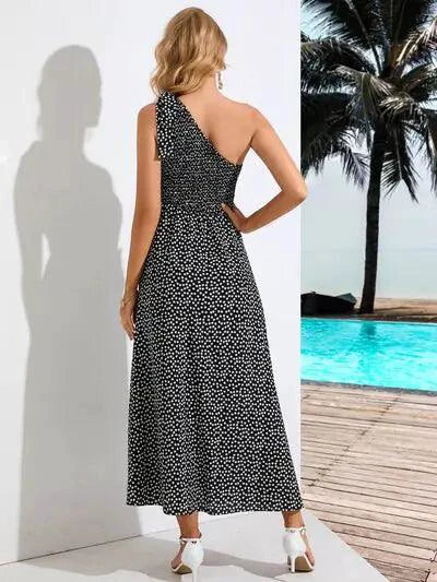 Mandotos Zoe asymmetrical midi dress shown in black fabric, featuring unique hemline and elegant sleeveless design.