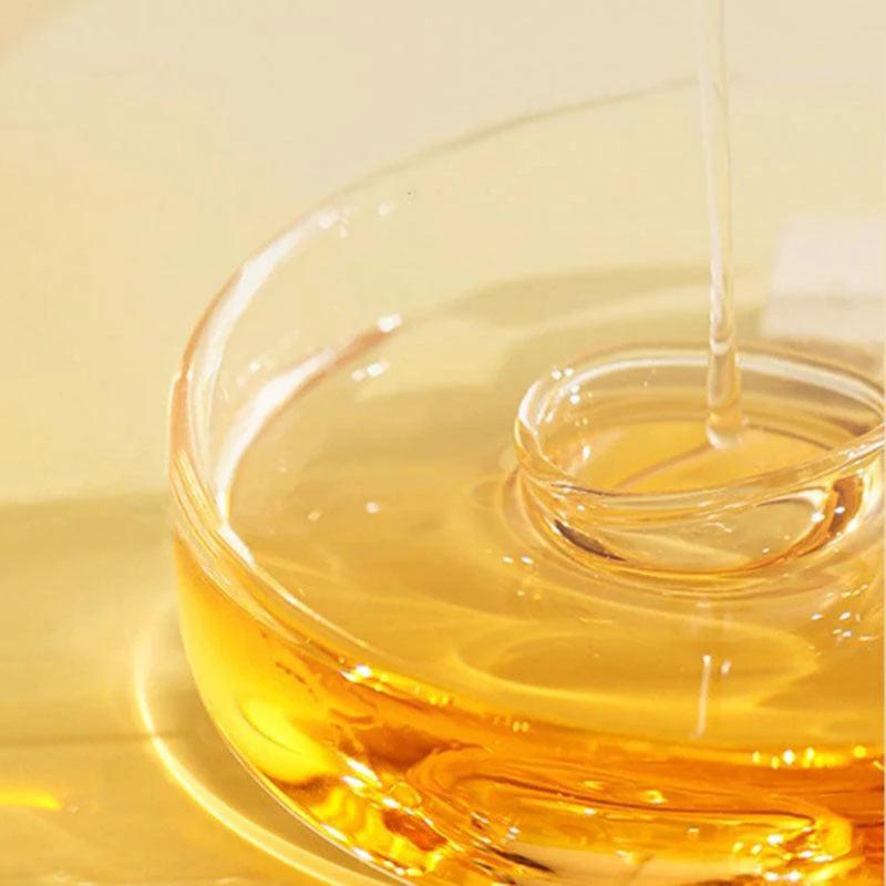 Bottle of Perfume Soft Hair Care Oil, a nourishing anti-static spray for frizz-free, hydrated hair, with a sleek design.