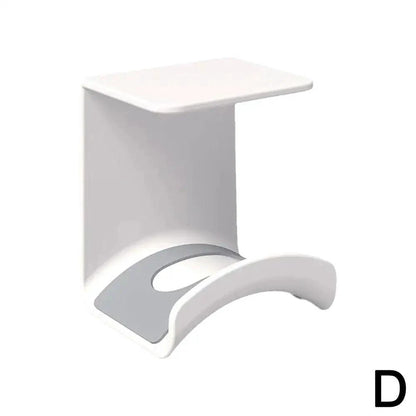 Plastic wall-mounted headphone stand and gaming headset holder with adhesive strip for under-desk earphone organization.