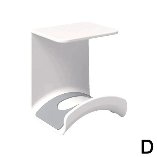 Plastic wall-mounted headphone stand and gaming headset holder with adhesive strip for under-desk earphone organization.