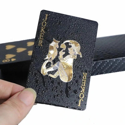Black and gold waterproof playing cards from Dmagic, featuring poker suits, perfect for magic tricks and card games.