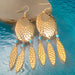 Navette Dream Catcher Earrings by The Urban Charm featuring turquoise accents, feathers, and intricate metalwork.